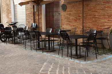 Tables and chairs near building. Outdoor cafe
