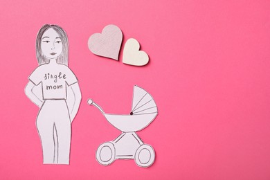 Photo of Being single mother concept. Woman with pram made of paper on pink background, flat lay. Space for text
