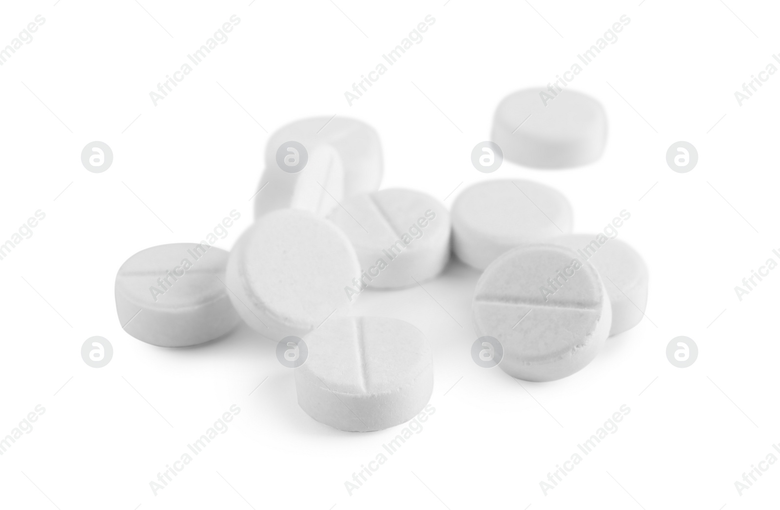 Photo of Pile of round pills on white background