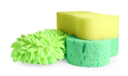 Photo of Sponges and car wash mitt on white background
