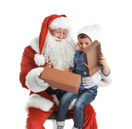 Little boy receiving gift from authentic Santa Claus on white background