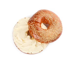 Photo of Delicious fresh bagel with cream cheese on white background, top view