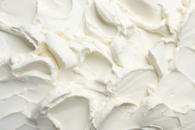 Photo of Closeup of tasty cream cheese as background, top view