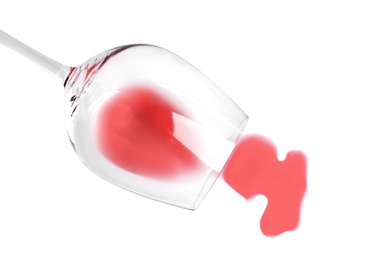 Photo of Transparent glass and spilled exquisite red wine on white background, top view