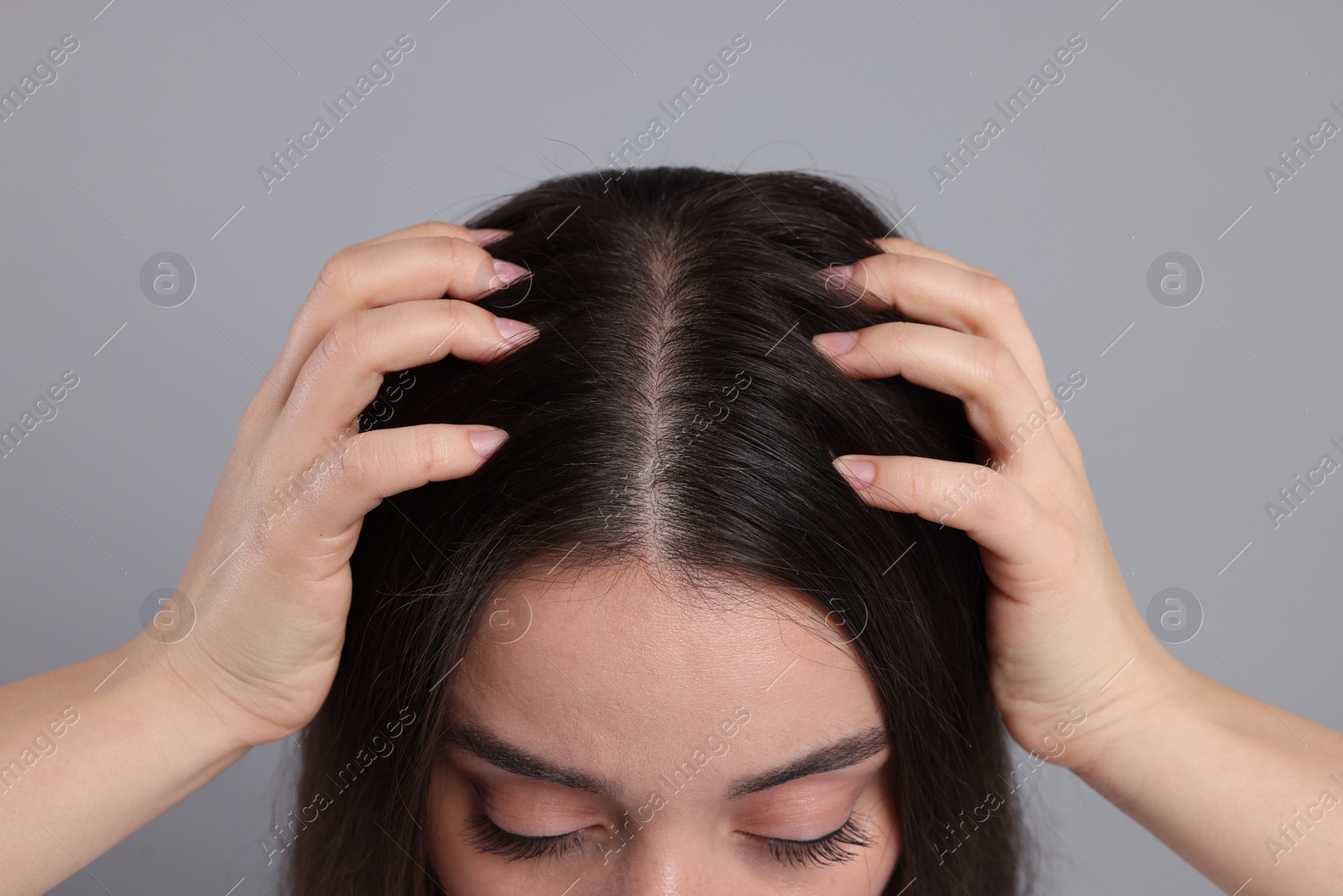 Photo of Woman with healthy hair on grey background, closeup