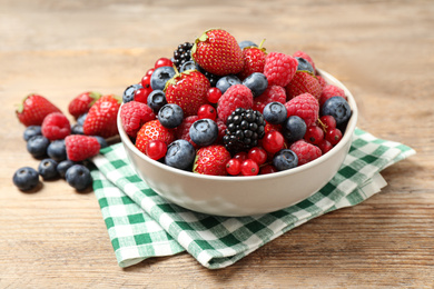 Photo of Mix of ripe berries on wooden table