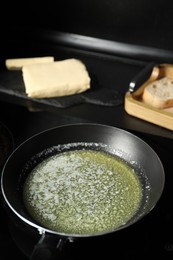 Photo of Melting butter in frying pan on table