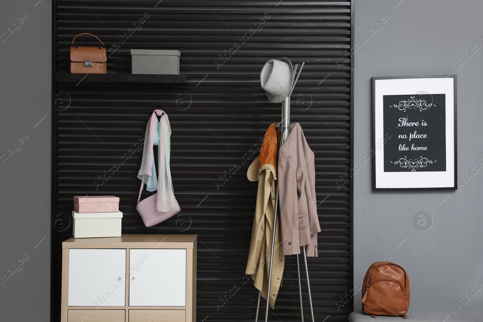 Photo of Hallway interior with stylish furniture, clothes and accessories