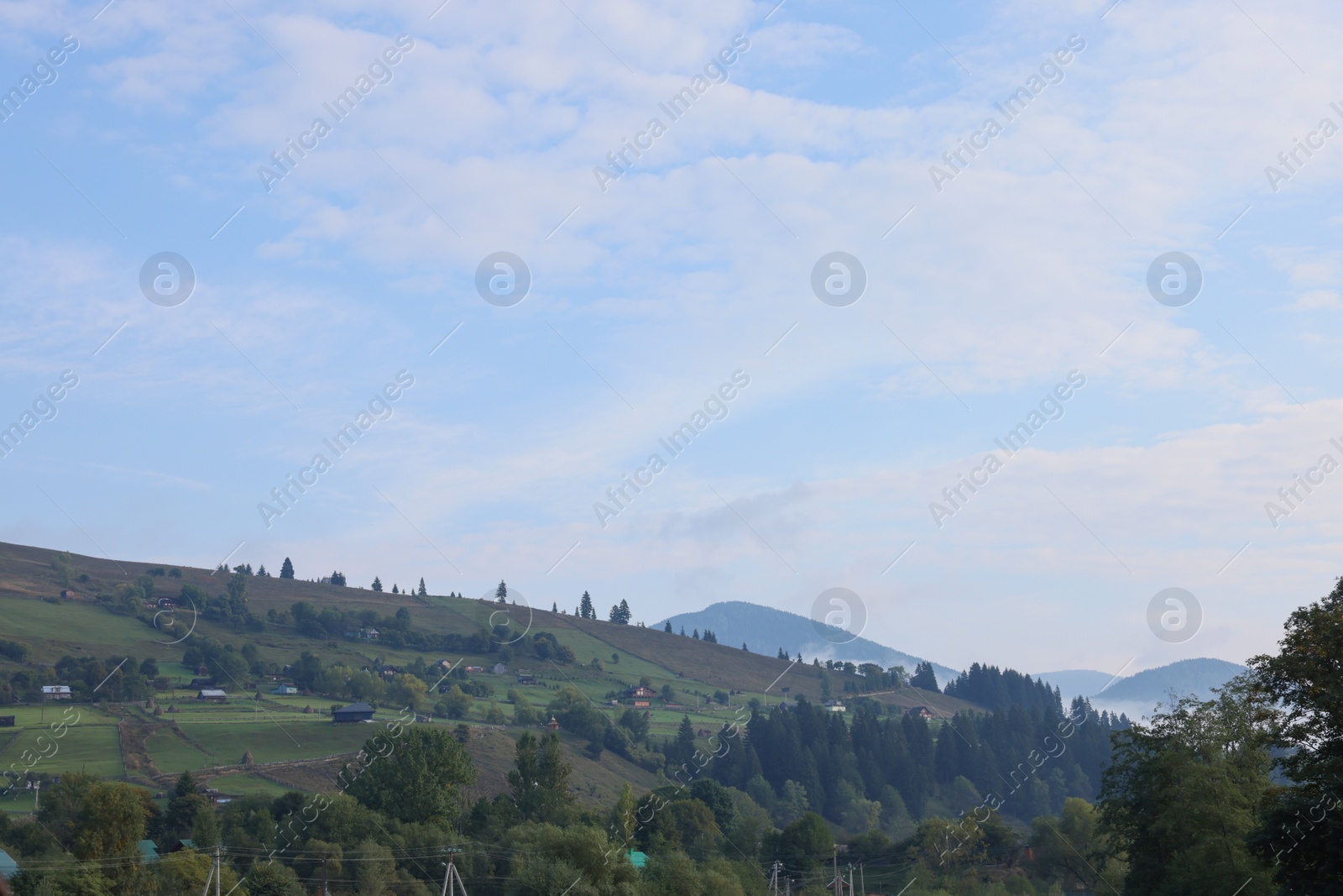 Photo of Beautiful view of village on mountain slopes in morning