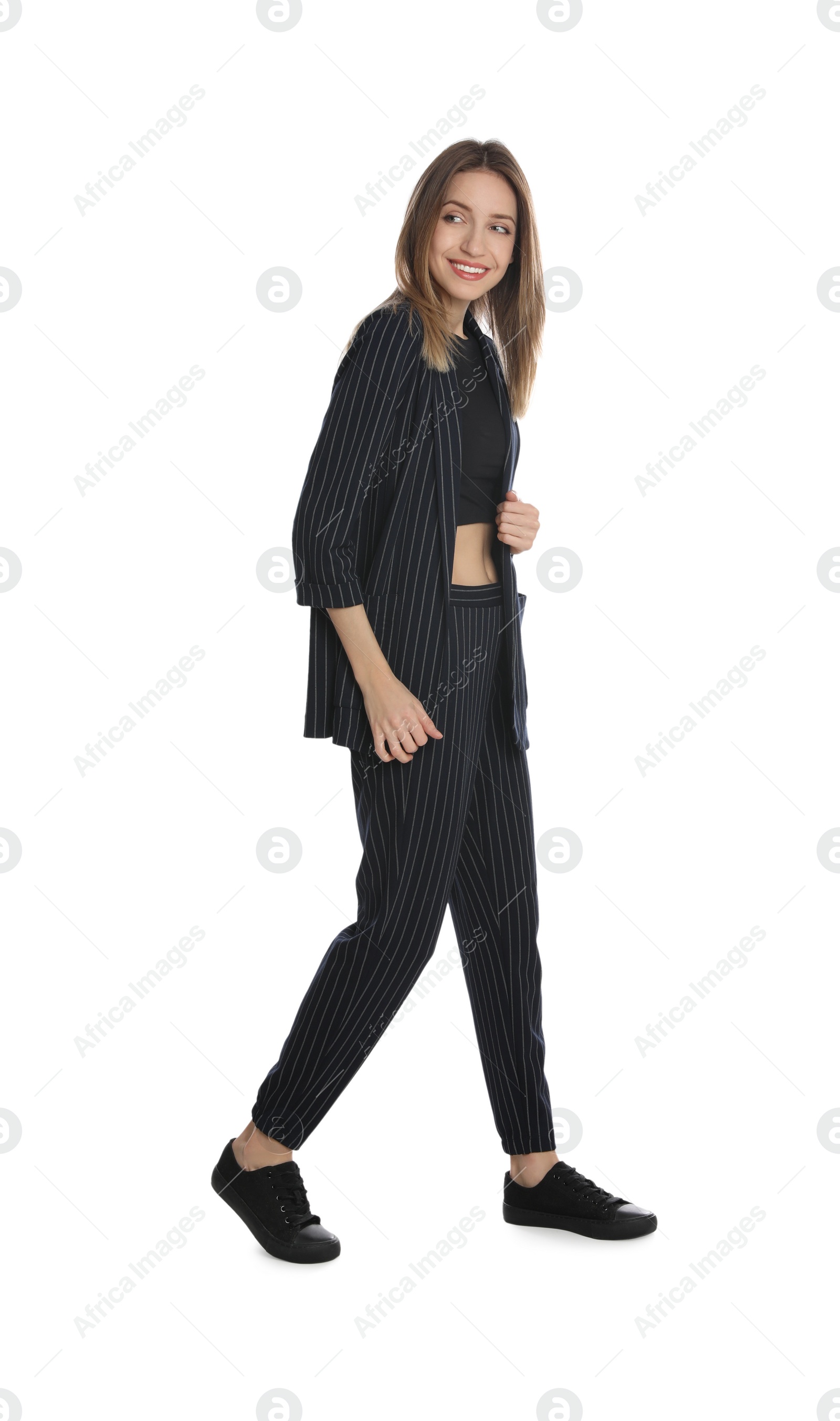 Photo of Full length portrait of beautiful young woman in fashionable suit on white background. Business attire