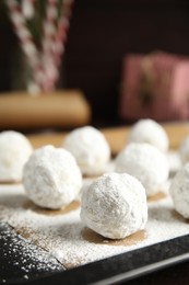 Photo of Christmas snowball cookies on baking tray, closeup