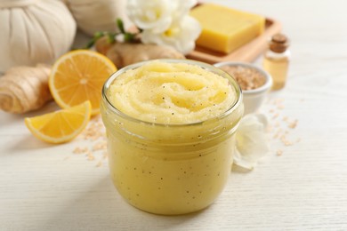 Body scrub in glass jar on white wooden table, closeup