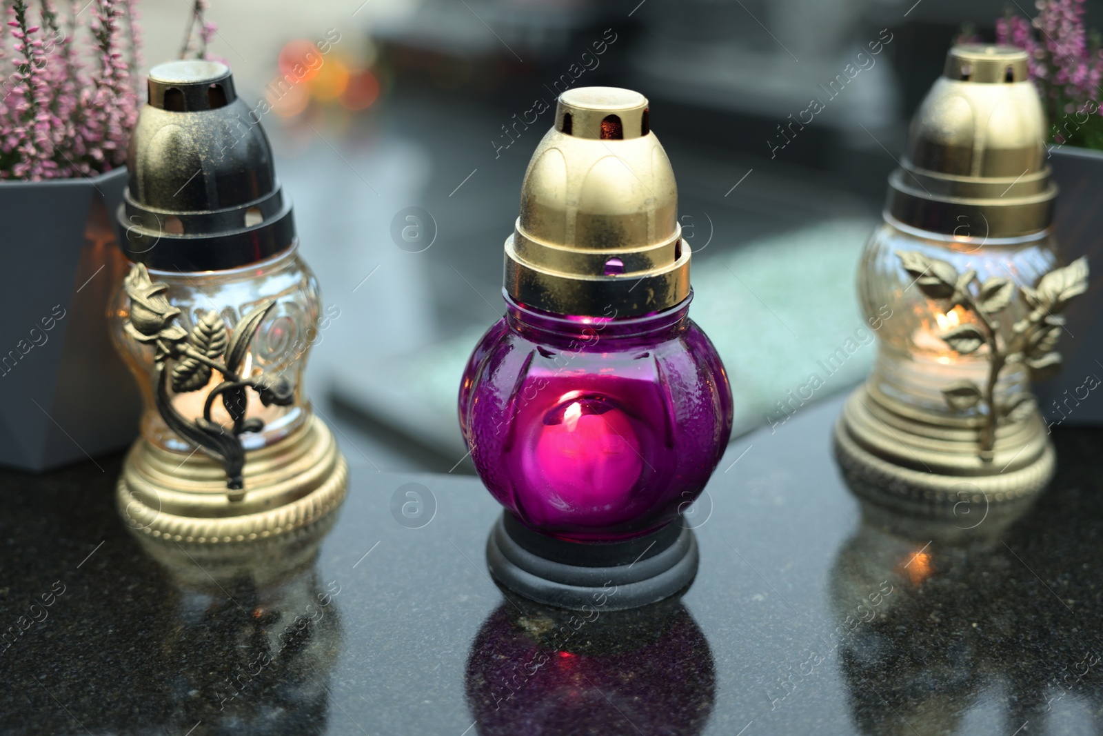 Photo of Grave lights on granite surface at cemetery