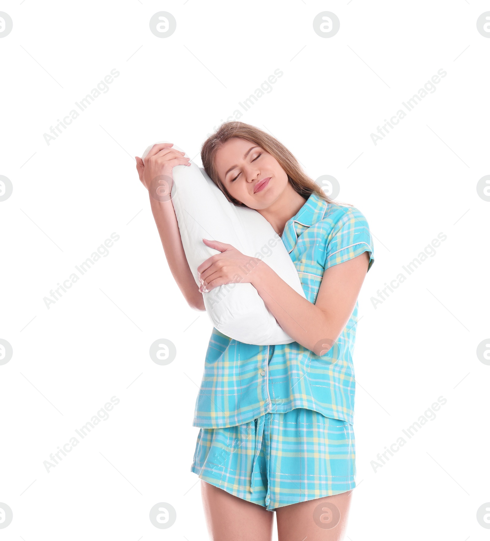 Photo of Young woman in pajamas embracing pillow on white background