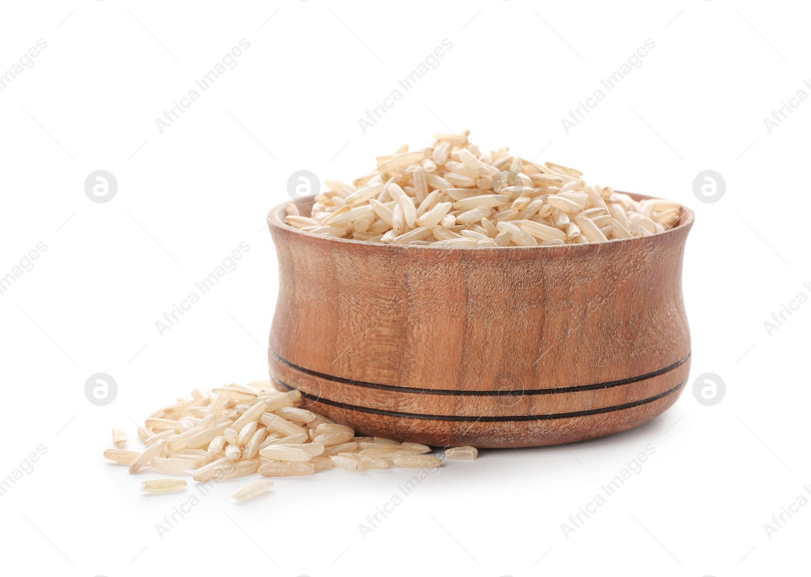 Photo of Wooden bowl with brown rice on white background