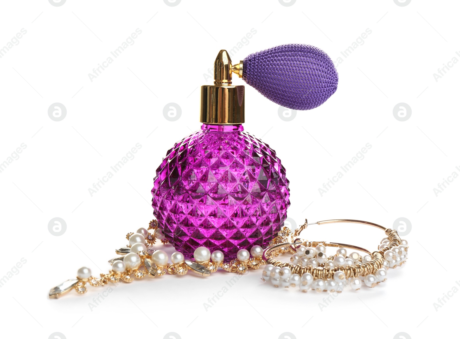 Photo of Glass bottle of perfume and luxury jewellery isolated on white