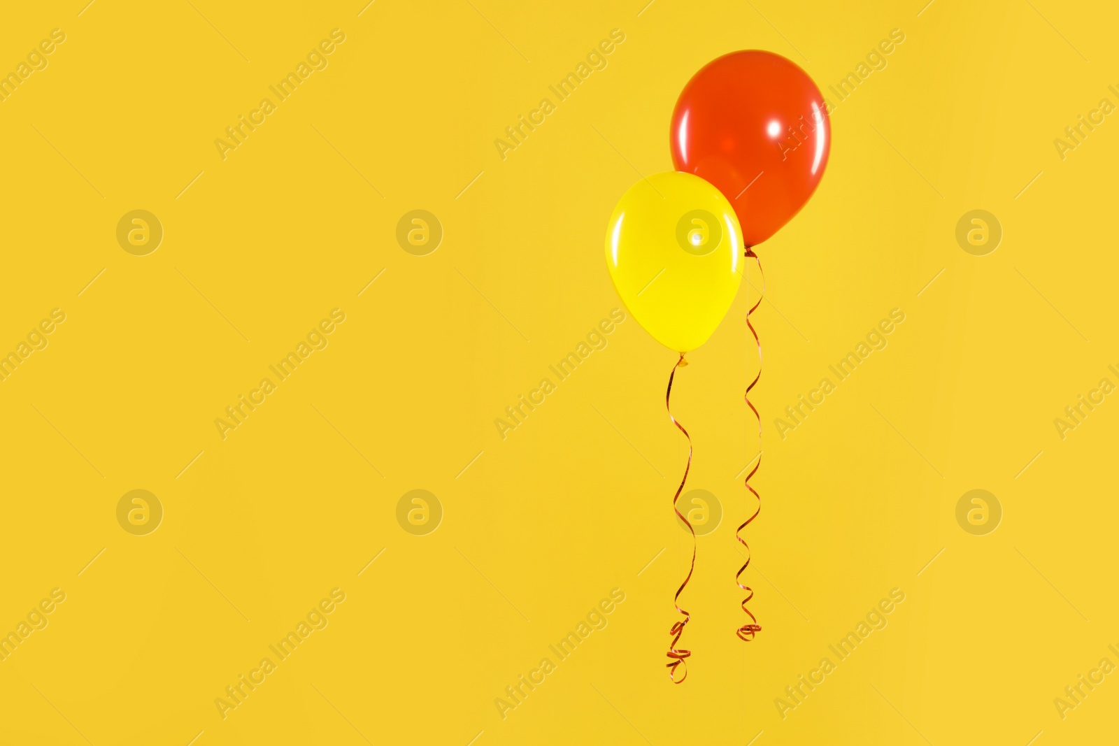 Photo of Bright balloons on color background, space for text. Celebration time