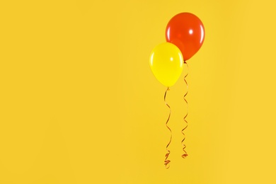 Bright balloons on color background, space for text. Celebration time