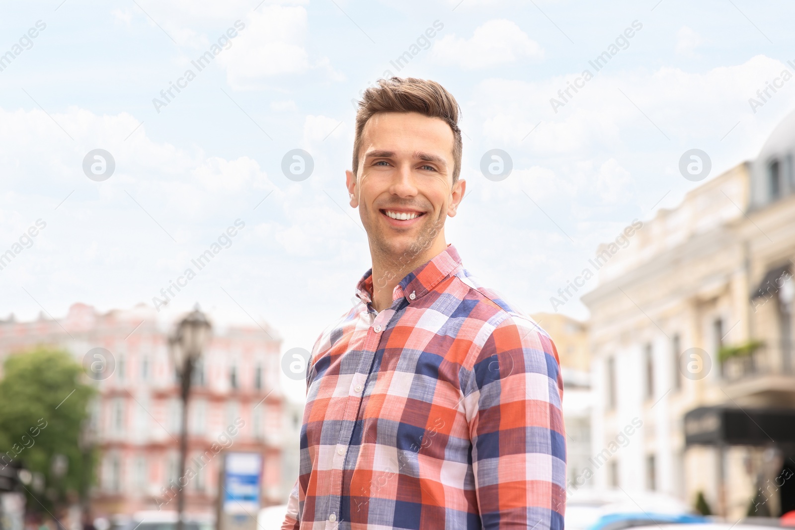 Photo of Portrait of attractive young man in stylish outfit outdoors