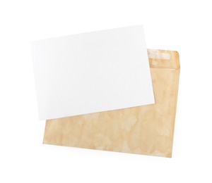 Photo of Old envelope with blank letter on white background, top view