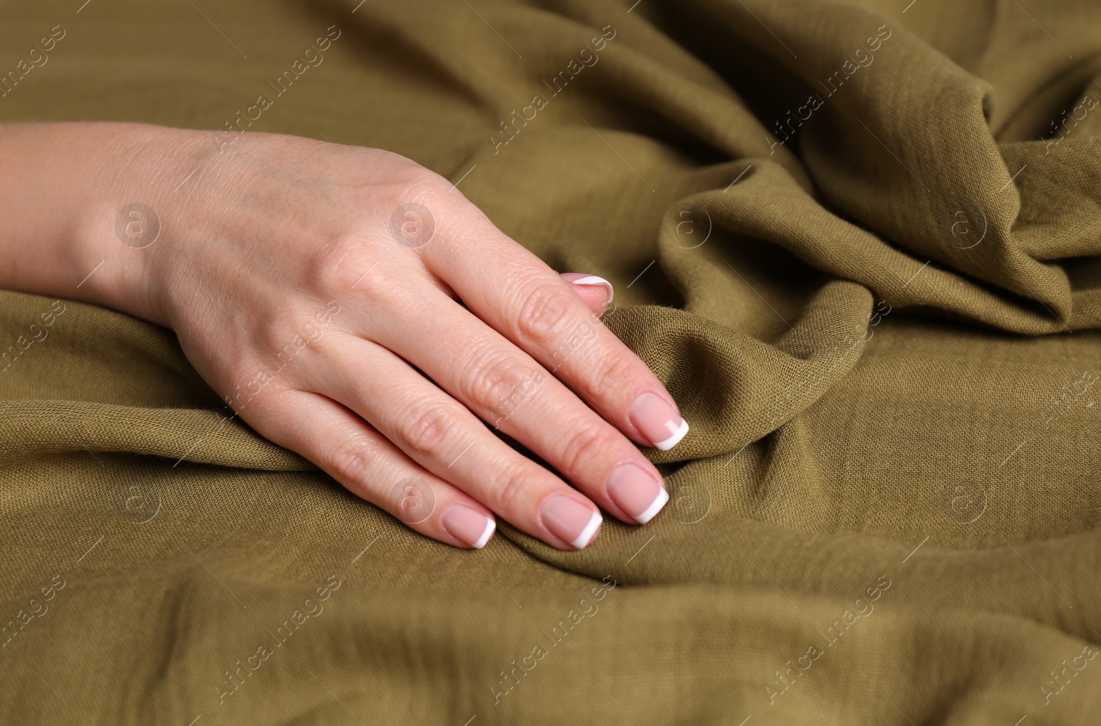 Photo of Woman touching soft linen fabric, closeup view