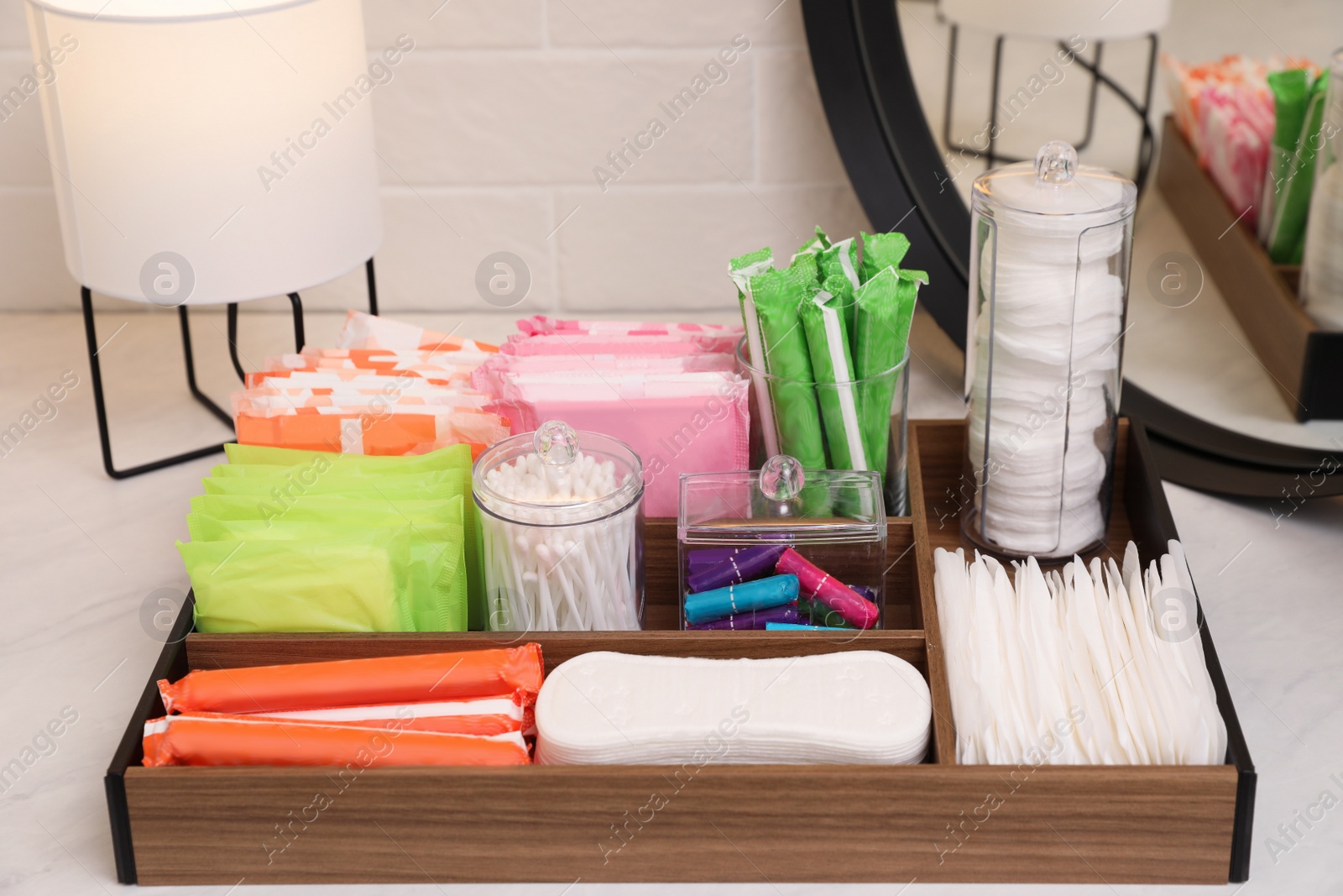 Photo of Wooden organizer with different feminine hygiene products on table