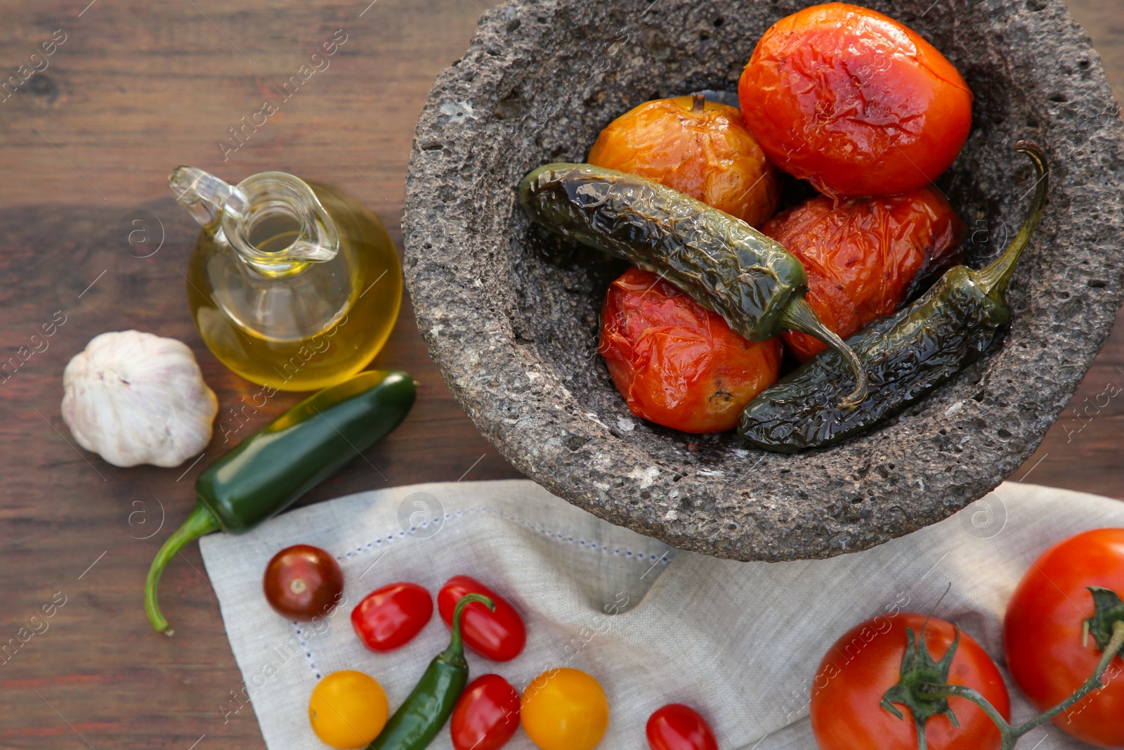 Photo of Ingredients for tasty salsa sauce and stone bowl on wooden table, flat lay