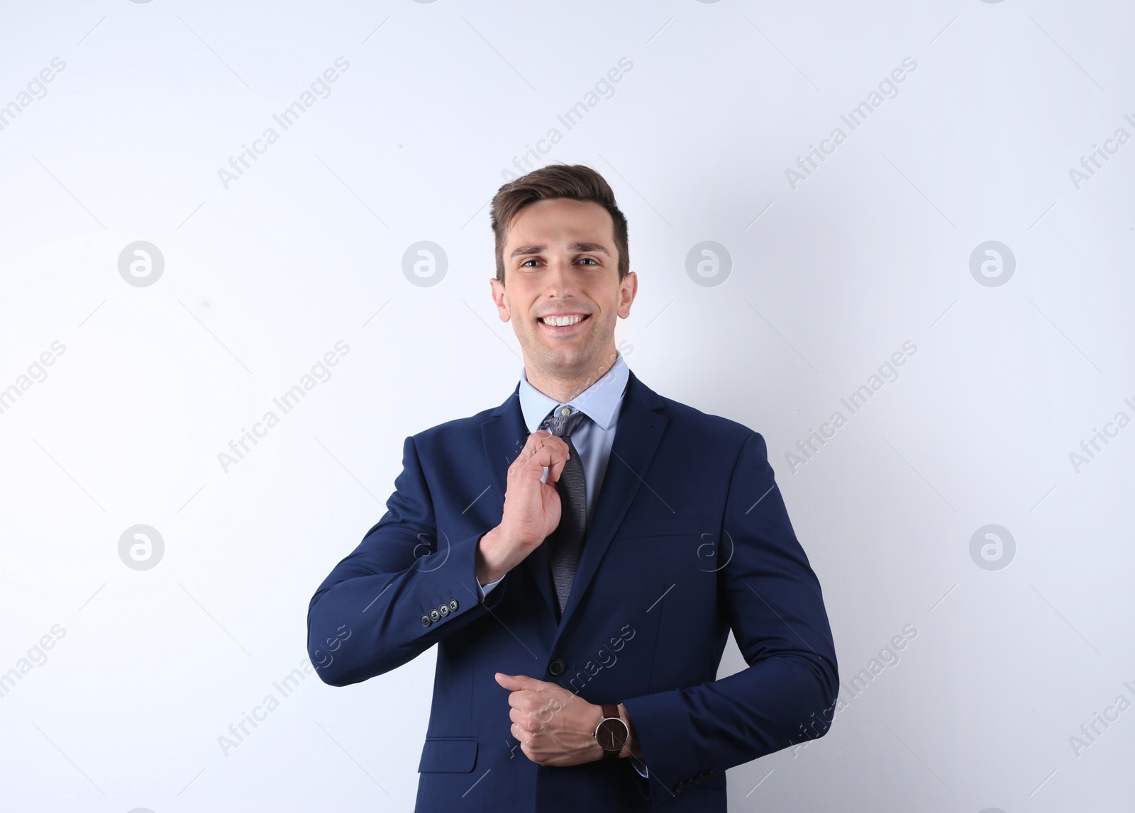 Photo of Handsome young man in suit on white background