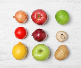 Photo of Flat lay composition with ripe fruits and vegetables on white wooden table