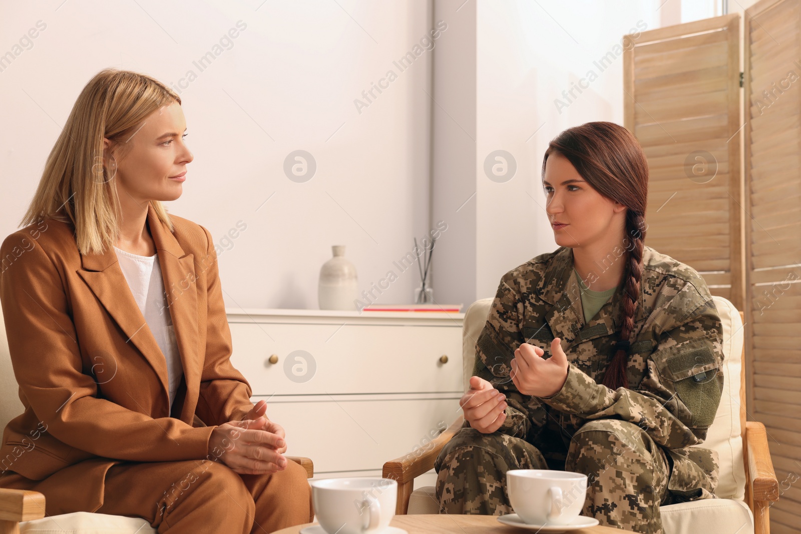 Photo of Psychologist working with female military officer in office