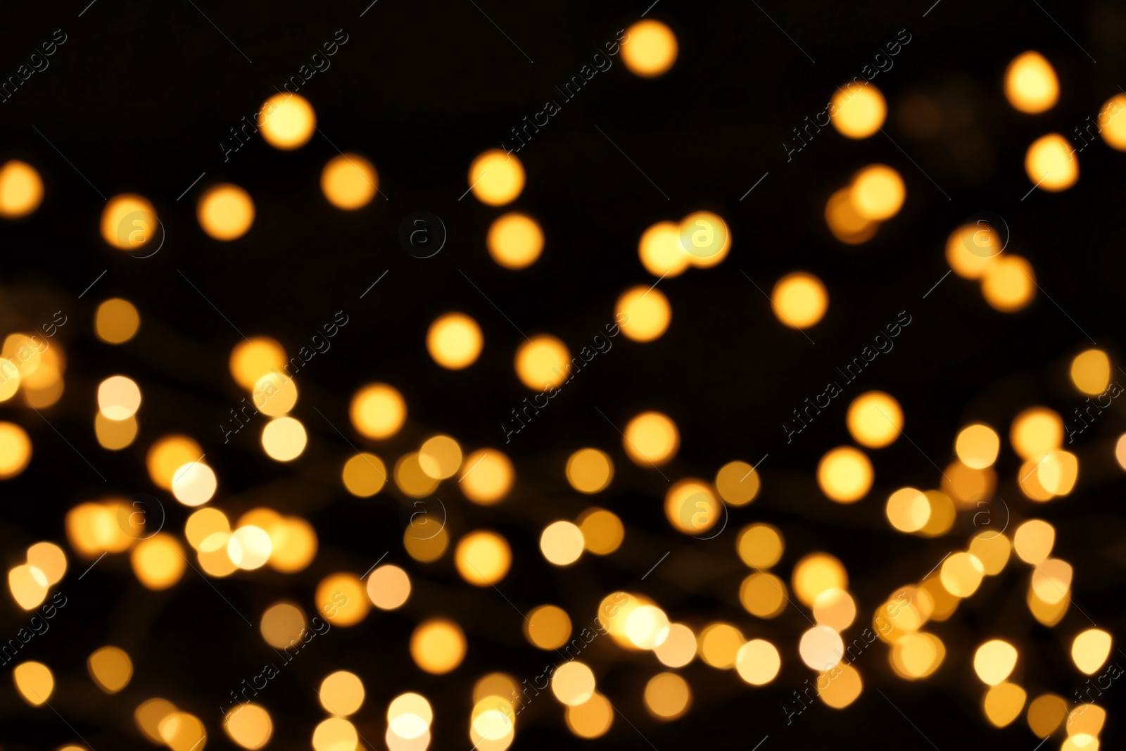 Photo of Beautiful golden lights on dark background. Bokeh effect