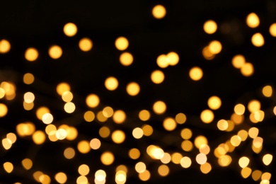 Beautiful golden lights on dark background. Bokeh effect