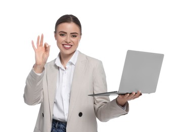 Photo of Happy woman with laptop showing okay gesture on white background