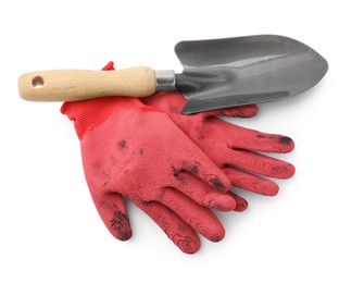 Photo of Pair of red gardening gloves and trowel isolated on white, top view