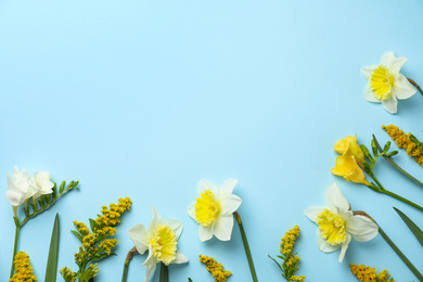 Photo of Flat lay composition with spring flowers on light blue background. Space for text