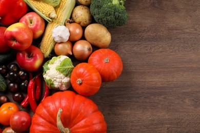 Different fresh ripe vegetables and fruits on wooden table, flat lay. Space for text