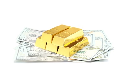 Photo of Shiny gold bars and money on white background