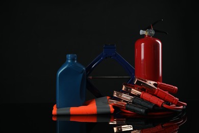 Set of car safety equipment on black background