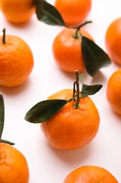 Fresh ripe tangerines with leaves on white background