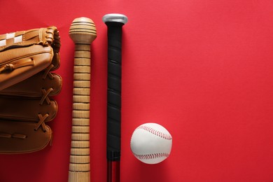 Photo of Baseball glove, bats, ball and batting helmet on red background, flat lay. Space for text