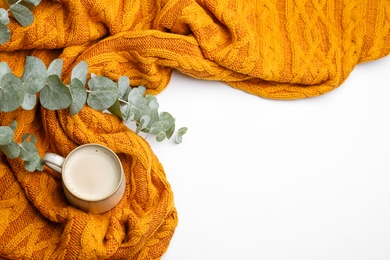 Flat lay composition with coffee and warm plaid on white background, space for text