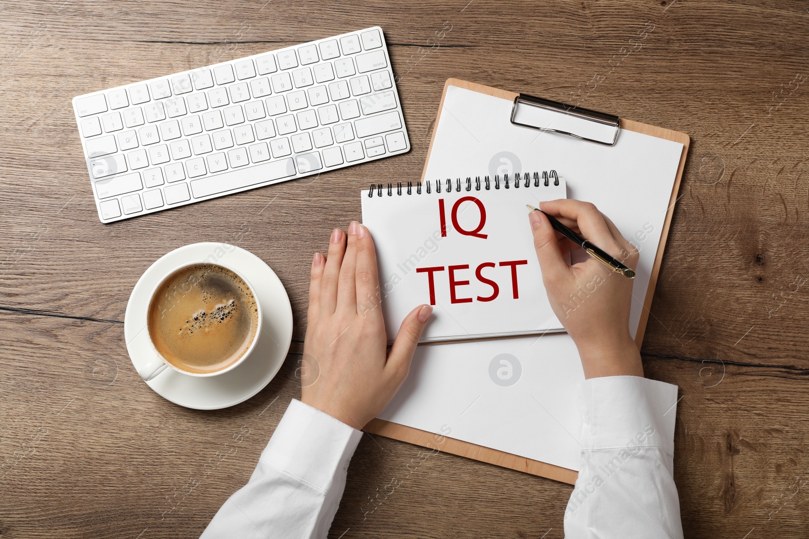 Image of IQ Test. Woman with pen and notebook at wooden table, top view