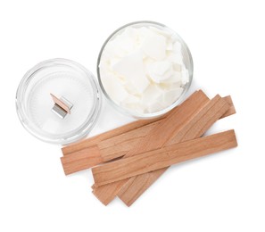 Photo of Wax flakes and wooden wicks on white background, top view. Making homemade candle