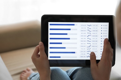 Woman working with tablet at home, closeup