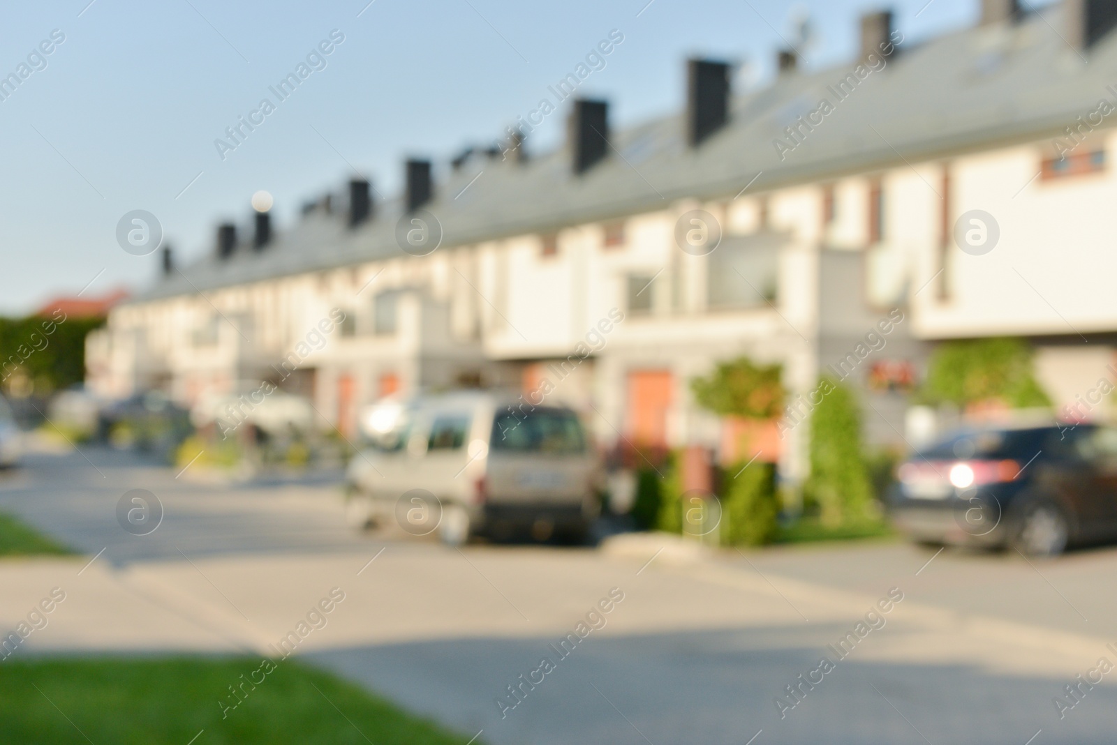 Photo of Blurred view of suburban street with beautiful houses