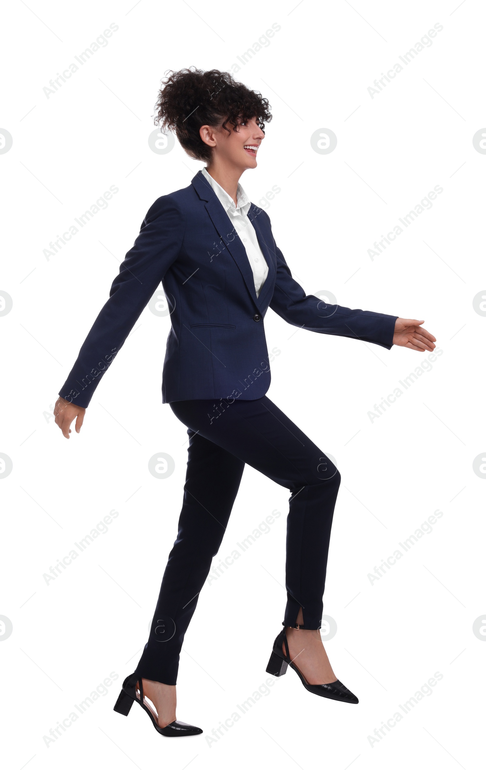 Photo of Beautiful businesswoman in suit walking on white background