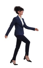 Photo of Beautiful businesswoman in suit walking on white background