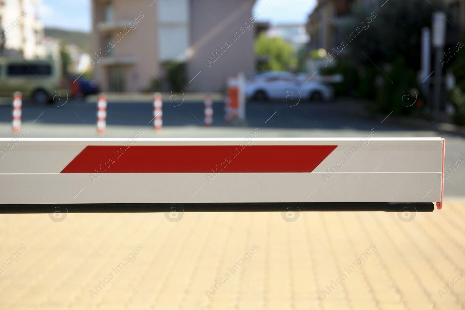 Photo of Closed boom barrier in city on sunny day, closeup