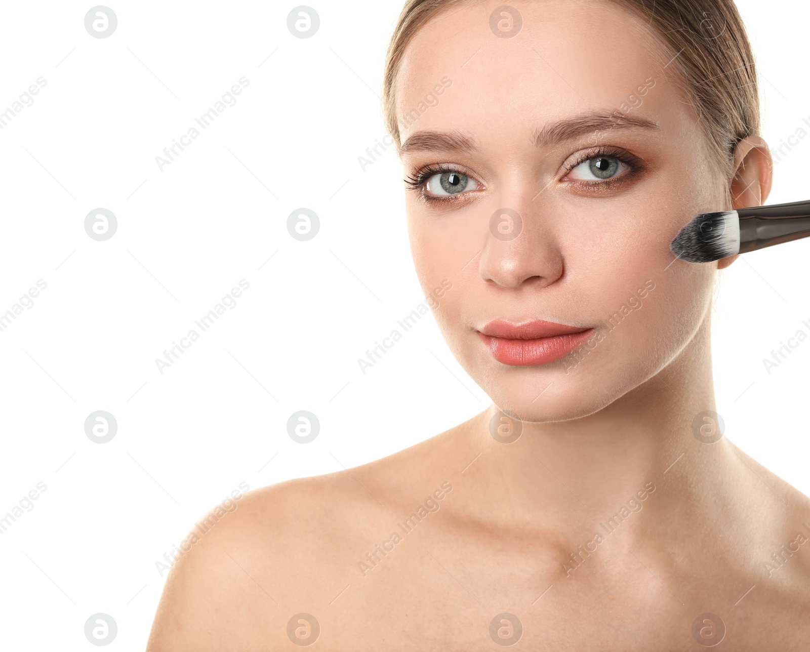 Photo of Portrait of beautiful young woman with makeup brush on white background