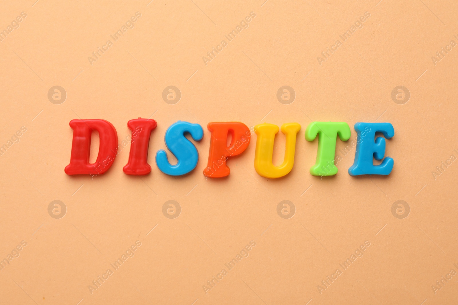 Photo of Word Dispute made of colorful letters on pale orange background, flat lay